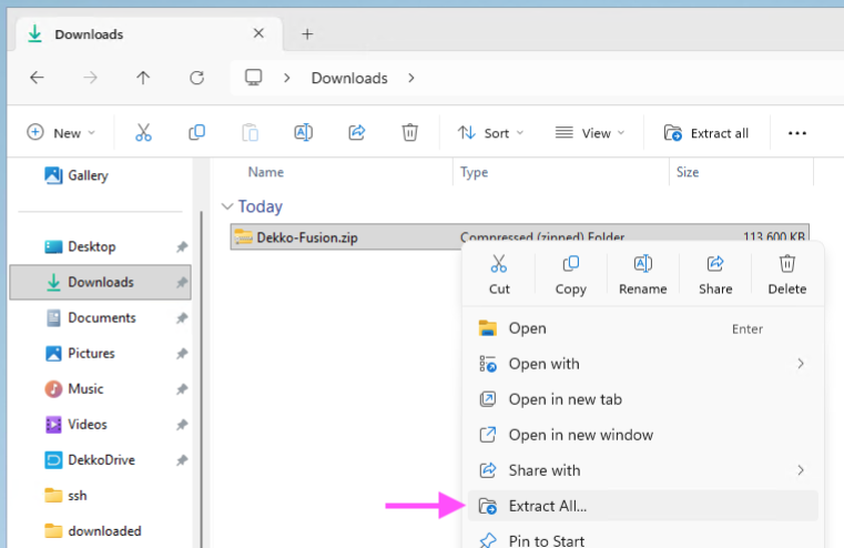 Windows File Explorer context menu for Dekko-Fusion.zip in Downloads, with the "Extract All..." option highlighted by a pink arrow.